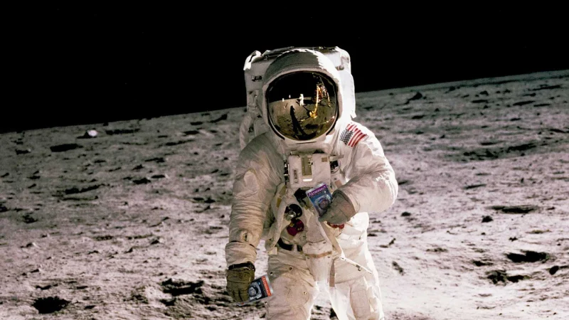 Doctored photograph of Neil Armstrong holding Astronaut Food freeze dried ice cream on the moon.