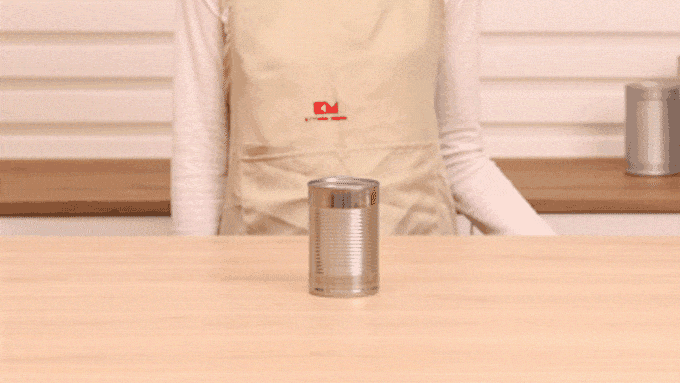 GIF showing how to place the Kitchen Mama Orbit One Can Opener on a can.