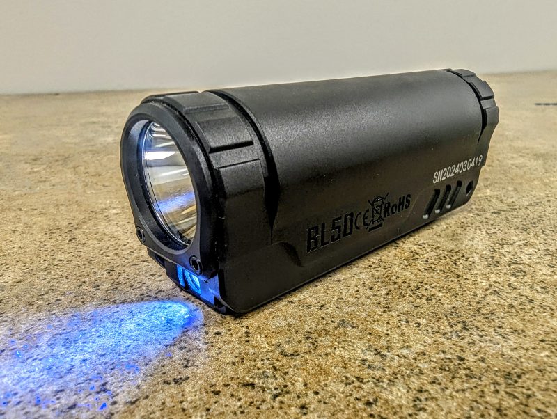 Side view of the IMALENT BL50 with the 365nm UV LED turned on.