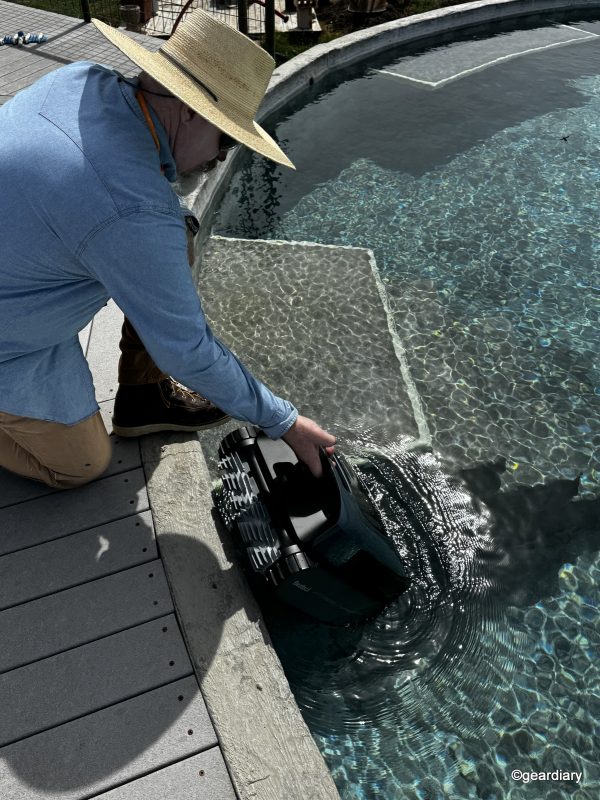 Kev slipping the Beatbot Aquasense Pro into the water