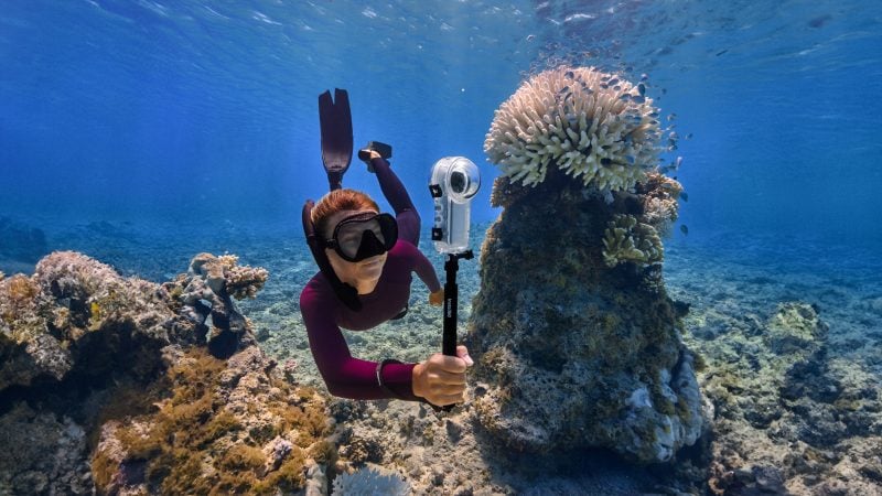 A diver using the Insta360 X4 underwater