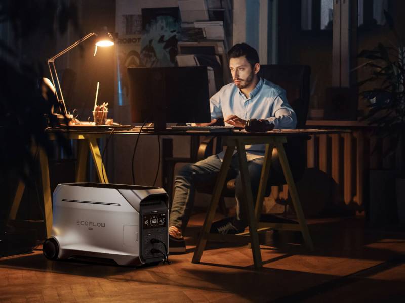 A man working at his desk with power generated from the EcoFlow DETA Pro 3