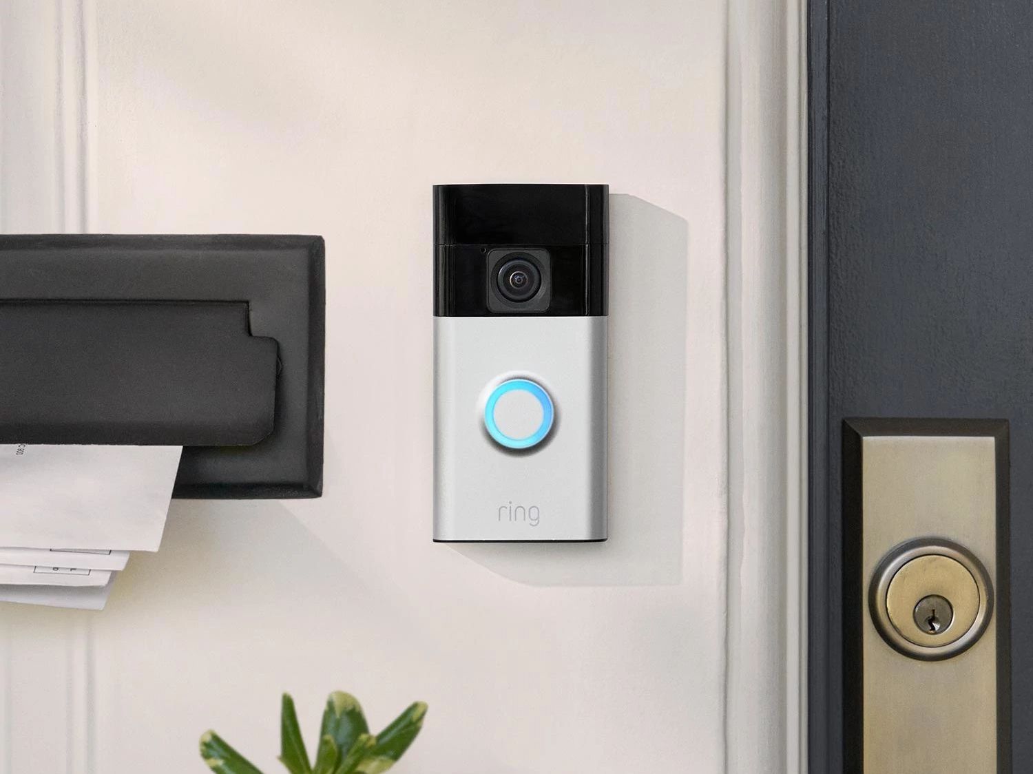 The Ring Battery Doorbell mounted by the front door of a home.