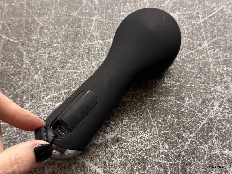 The back of the COSLUS Facial Cleansing Brush with the rubber charging cover open.