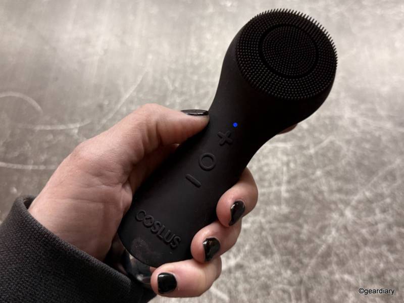 COSLUS Facial Cleansing Brush in the author's hand.