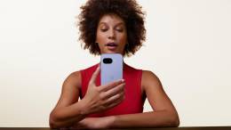 Woman holding a Google Pixel 9a