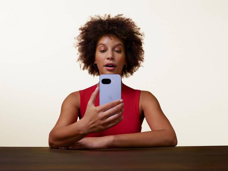 Woman holding a Google Pixel 9a