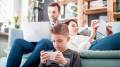 A family together while all on their devices.