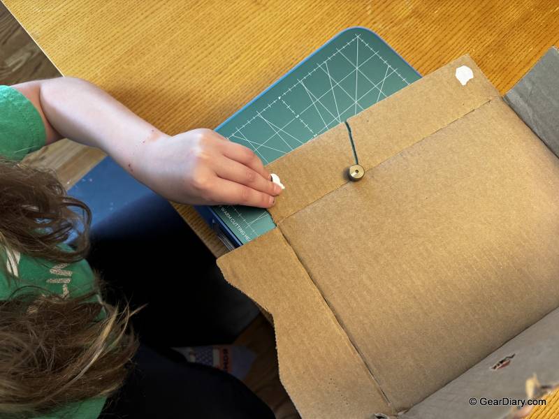 The author's son cutting cardboard with the ChompSaw