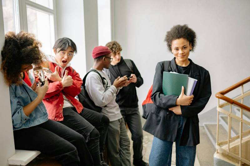 Photo of high school students hanging out in a stairwell.