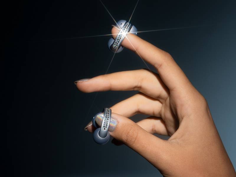 The Brilliant Collection - a hand holding a pair of moto buds loop