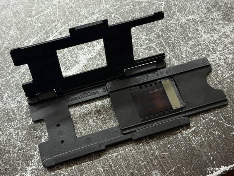 Loading a negative into the proper tray in order to feed it to the HP FilmScan 5-inch TouchScreen Film Scanner