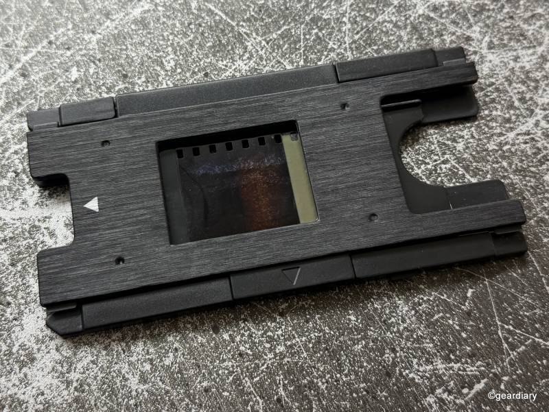 Loading a negative into the proper tray in order to feed it to the HP FilmScan 5-inch TouchScreen Film Scanner