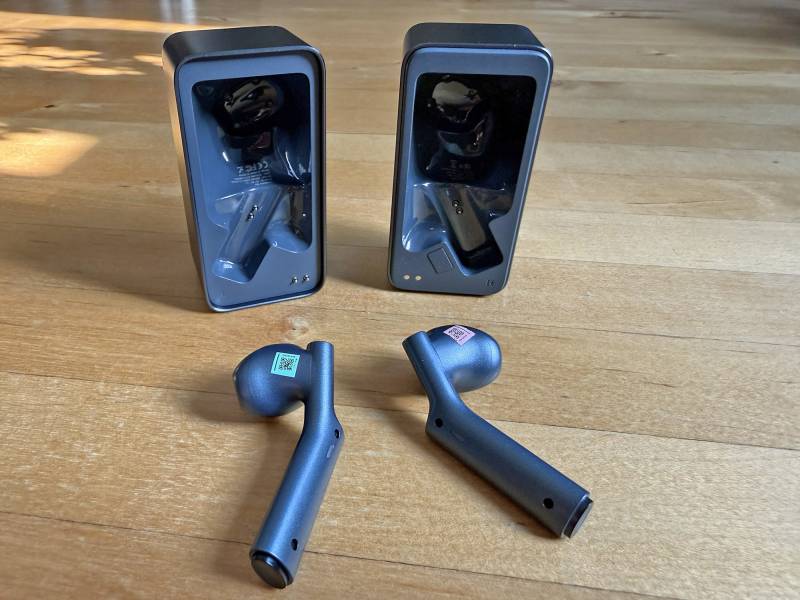 Timekettle W4 AI Interpreter Earbuds Review: Effortless, Accurate, Real-time Translations in an Elegant Package 2 Timekettle W4 AI Interpreter Earbuds with their charging case opened.
