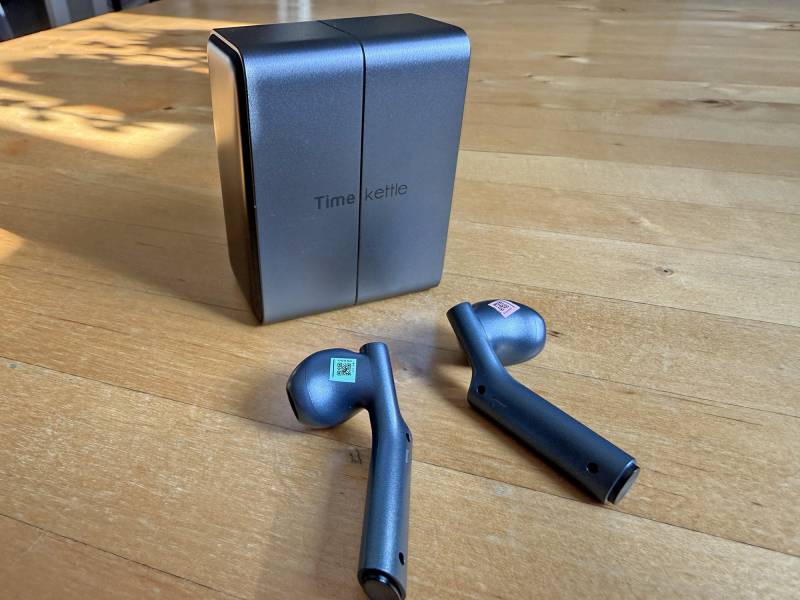 Timekettle W4 AI Interpreter Earbuds Review: Effortless, Accurate, Real-time Translations in an Elegant Package 1 Timekettle W4 AI Interpreter Earbuds and charging case.