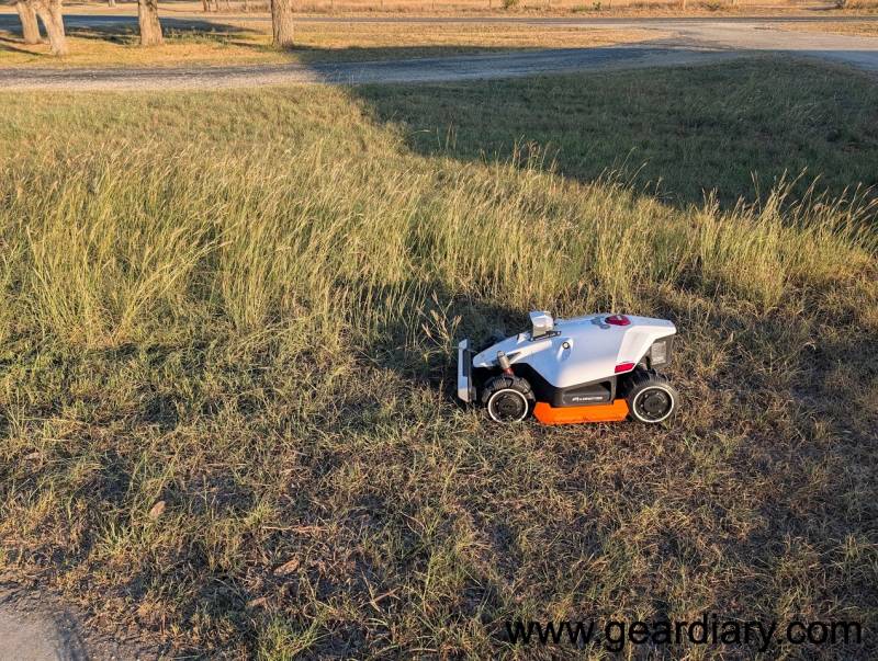 MAMMOTION LUBA 2 AWD H Version Review: A Monster Truck for Your Lawn That Actually Knows What It’s Doing 6 Mammotion Luba 2 AWD Robot Mower in the author's yard approaching tall grass