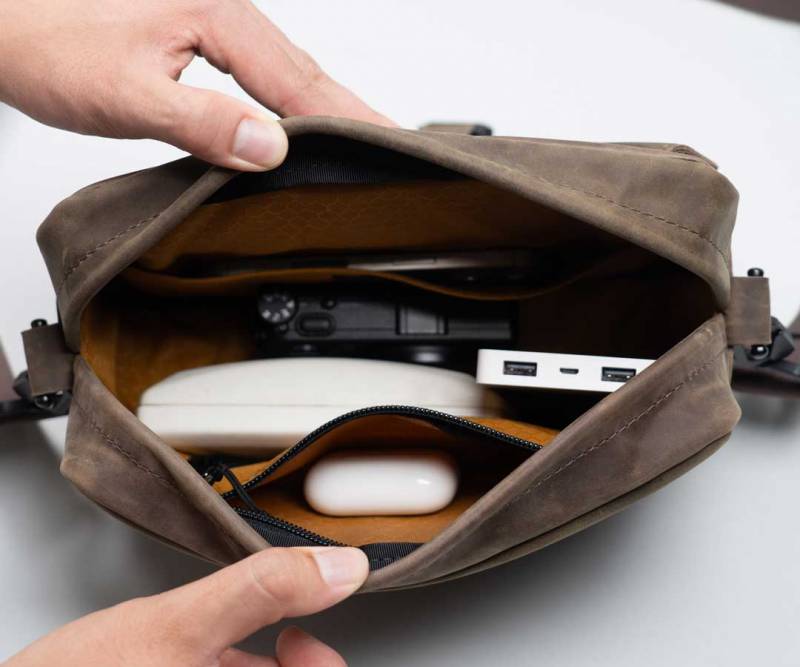 WaterField Hudson Leather Crossbody Review: A Handsome, Handcrafted EDC Bag That Marries Luxury and Function 11 WaterField Hudson Leather Crossbody with everyday gear inside of it.