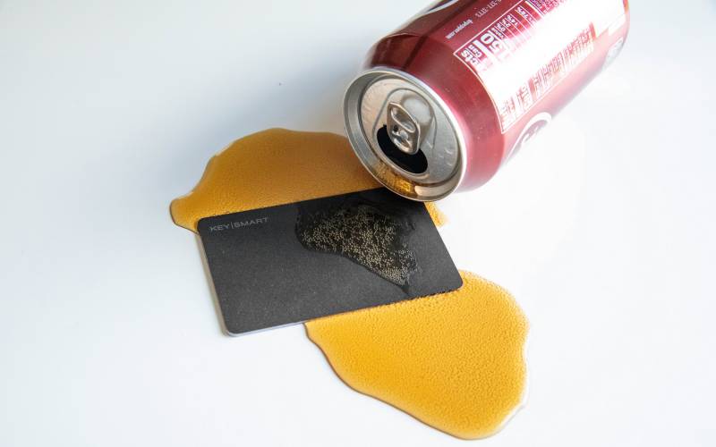 KeySmart SmartCard Makes Wallet Tracking Easy for Both Android and iOS Users 7 The KeySmart SmartCard laying in a spilled soda's mess.