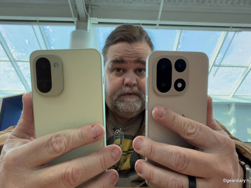 The author holding up the OnePlus 15R and OnePlus 15.