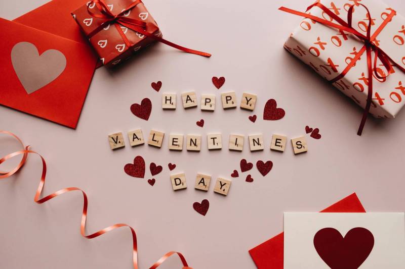Photo of wrapped gifts and the words "Happy Valentine's Day."