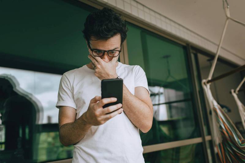 The Great Smartphone Slowdown: Are We Smarter Buyers, or Just Out of Reasons to Upgrade Annually? 1 Photo of a man looking at his smartphone in frustration