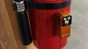 Olight Oclip Pro S magnetically attached to a fire extinguisher