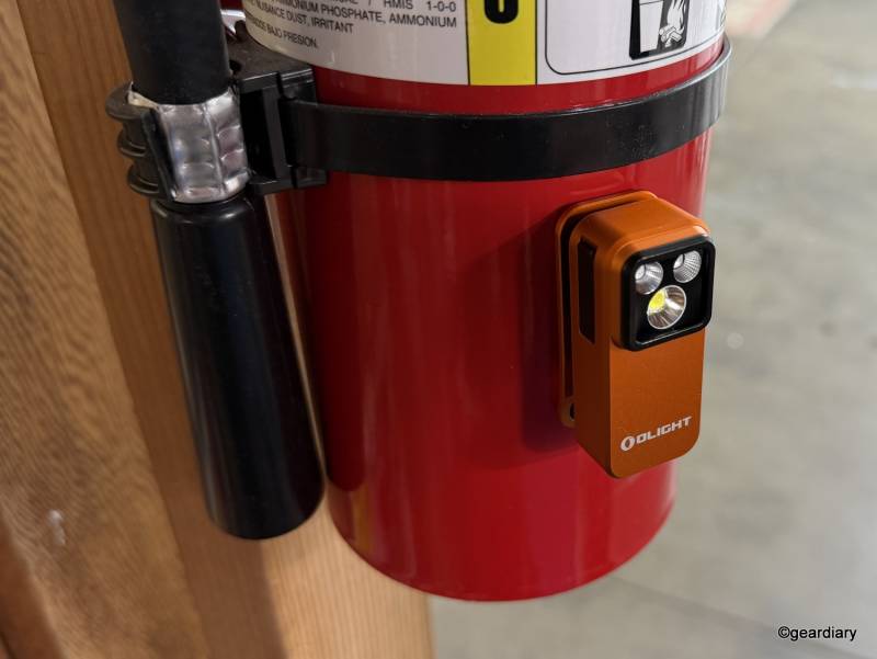 Olight Oclip Pro S magnetically attached to a fire extinguisher
