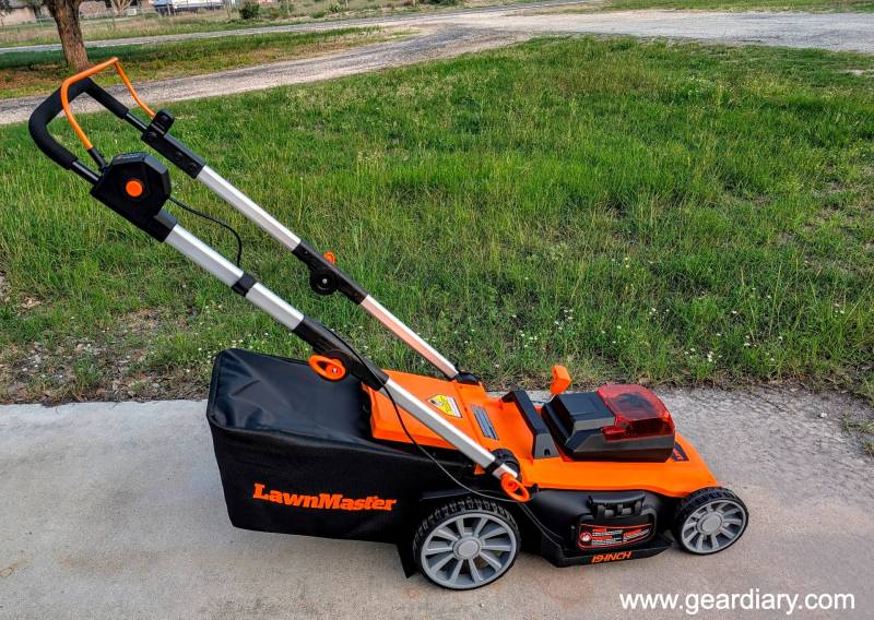 LawnMaster 48V Max 3-in-1 Brushless 19” Cordless Lawn Mower Review: Quiet, Lightweight, and Ready to Cut the Cord 1 The LawnMaster 48V Max 3-in-1 Brushless 19” Cordless Lawn Mower sitting next to the author's yard.