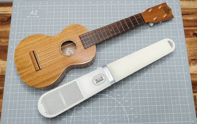 Enya Cyber-G Pocket Guitar next to a ukelele