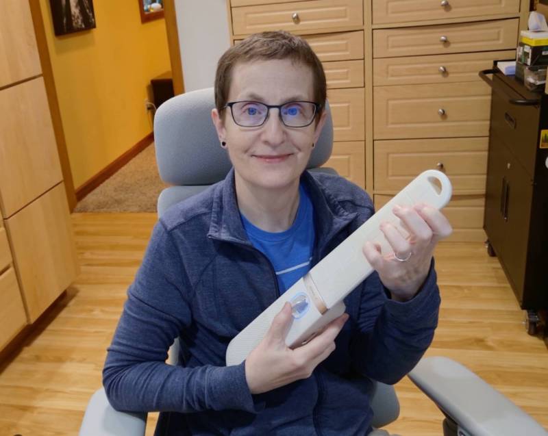 Julie holding the Enya Cyber-G Pocket Guitar