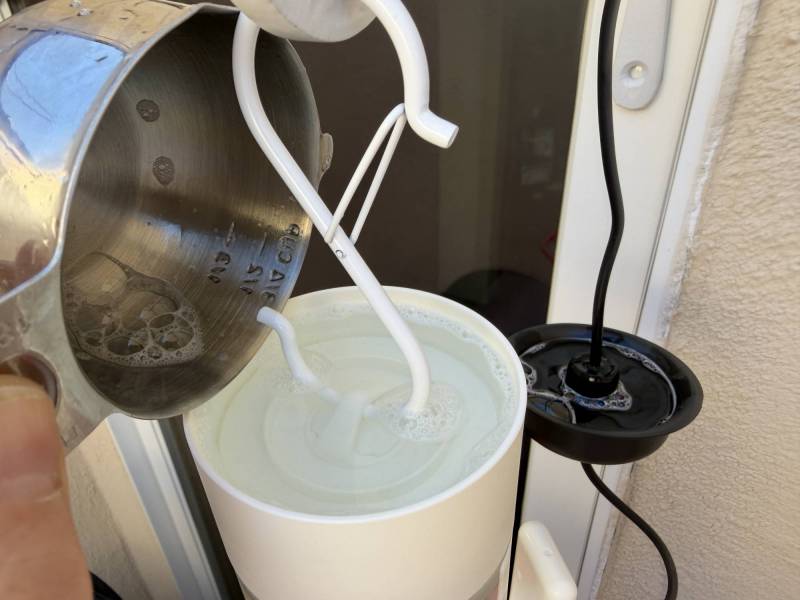 Birdfy Hum Feeder Duo Smart Hummingbird Feeder Review: Watch Nature's Acrobats in Action! 14 Adding soapy water to the Birdfy Hum Feeder Duo's moat.