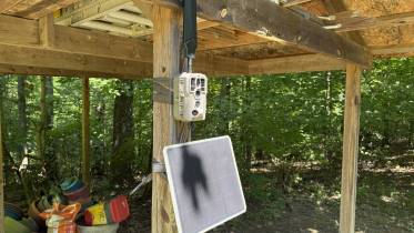 GardePro X66 Pro mounted on a post