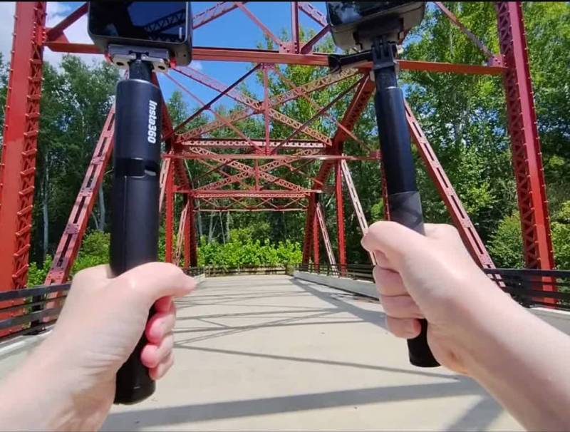 SJCAM SJ30 8K Dual-Lens Action Camera Review: Can It Compete with the Big Boys? 21 Holding two action cameras on selfie sticks