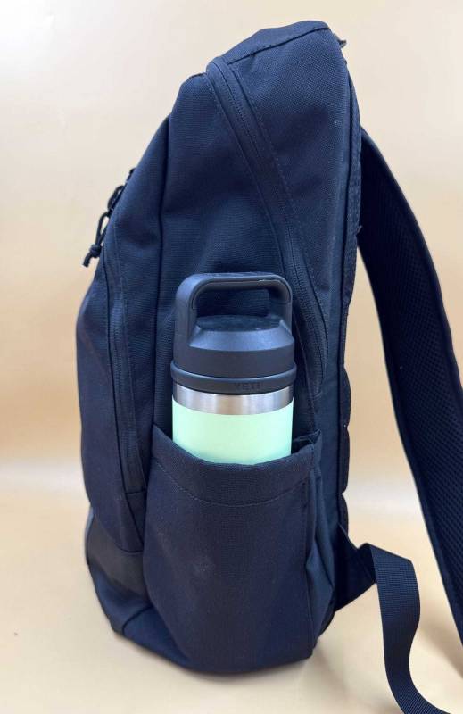 Chrome Industries Recruit 22L Pack Review: A Tough, Nimble Day Tripper That's Easy to Live With! 13 Chrome Industries Recruit 22L Pack holding a water bottle