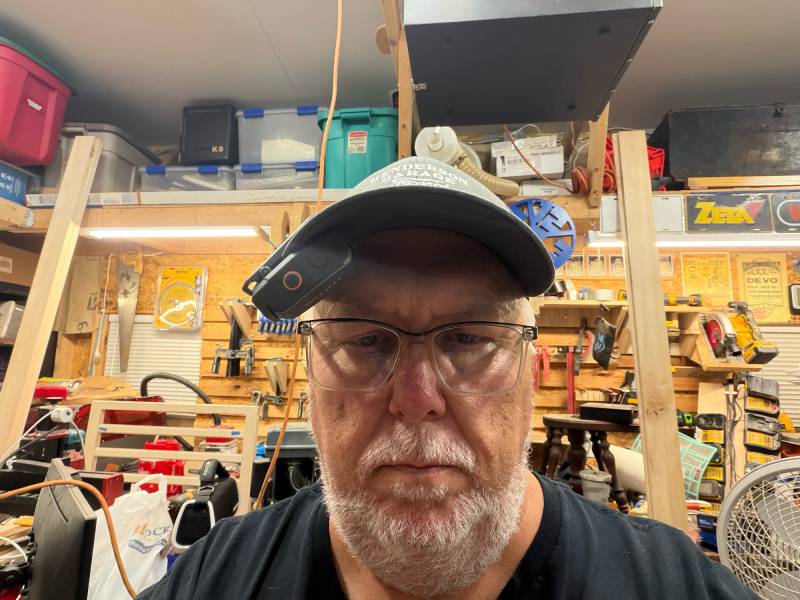 Mileseey GripSound Xmini/GripSense SmartAudio System Review: Tiny Speaker, Tough Build, and Surprisingly Powerful Noise Cancellation 6 The author wearing the Mileseey GripSound Xmini clipped to his hat
